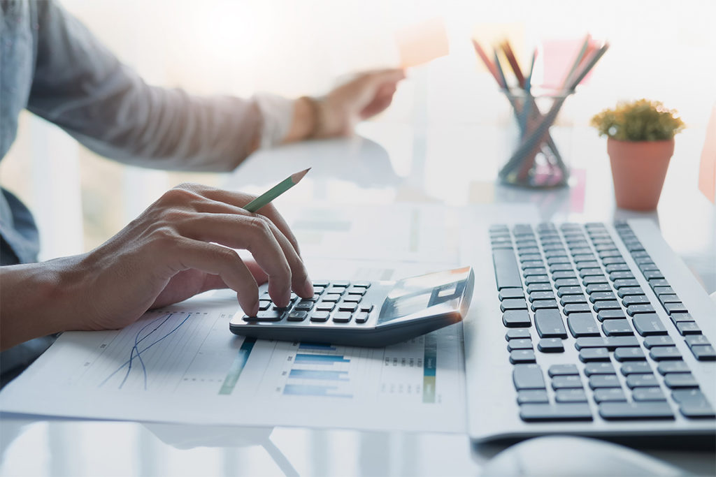 Businessman working on calculator