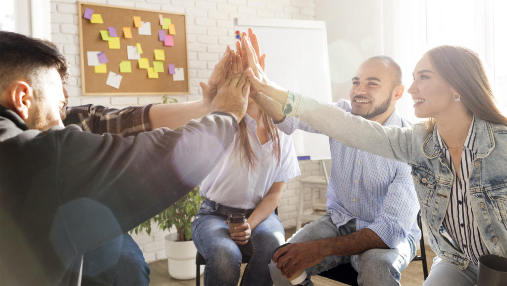 A group of people give each other a high five