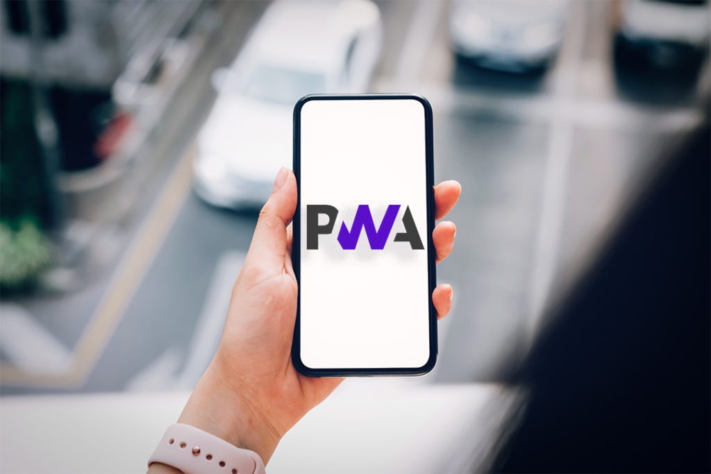 Woman holding a smartphone with the PWA word on the screen